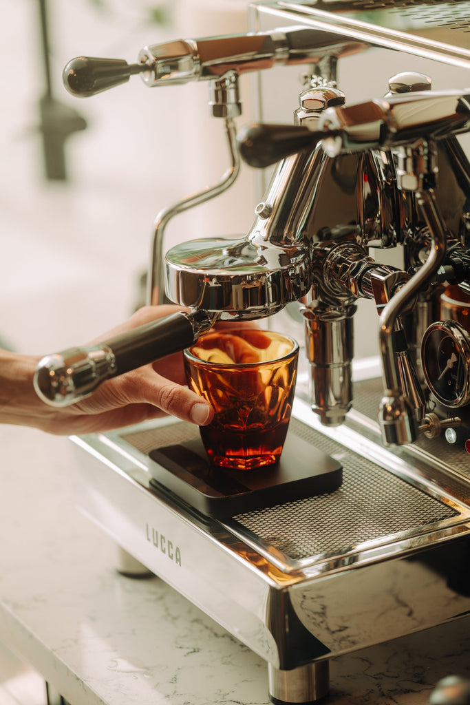 Weighing a shot on an espresso scale lifestyle by Clive Coffee