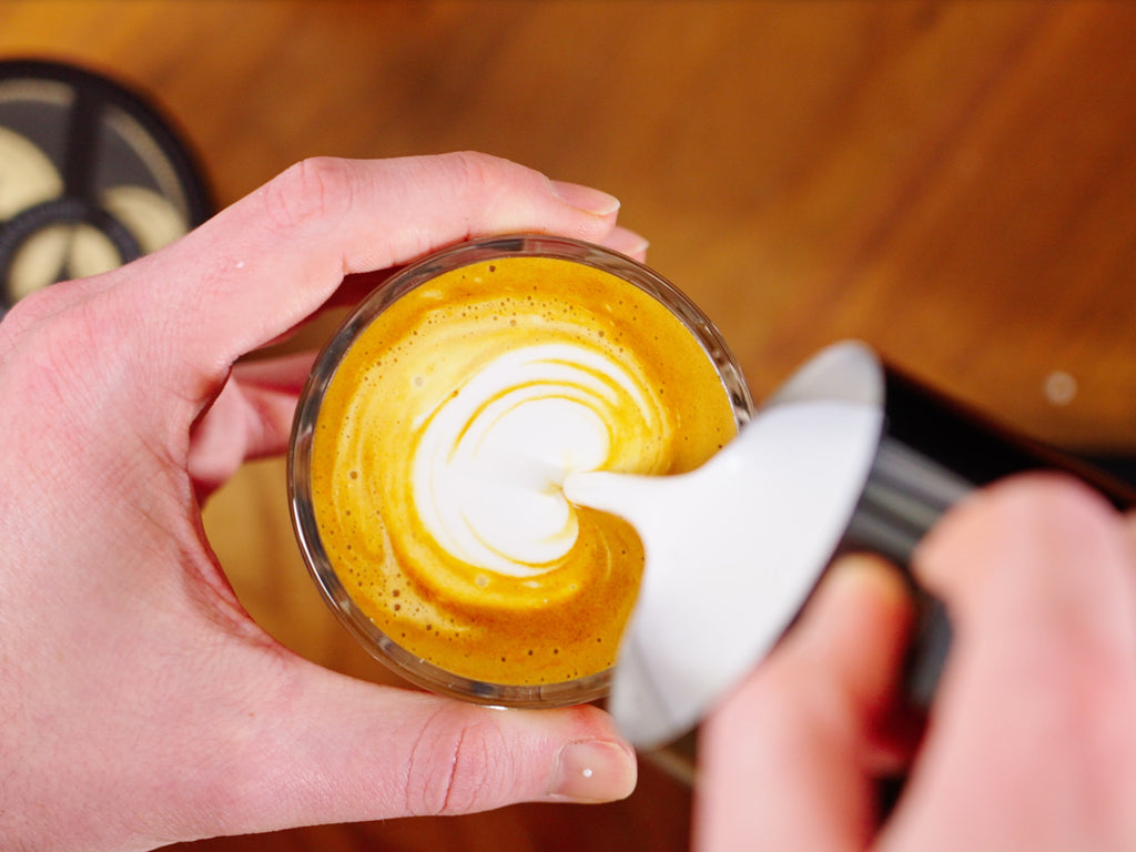 Pouring latte art lifestyle by clive coffee