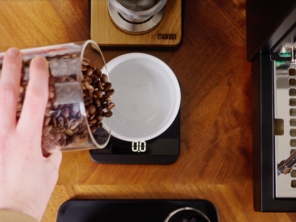 pouring beans into a bowl on a coffee scale lifestyle by clive coffee