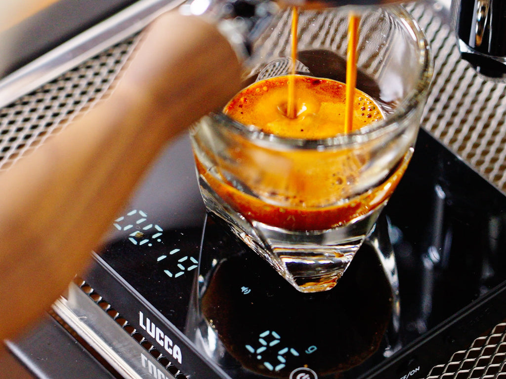 shot pulling into a glass on top of a scale lifestyle by clive coffee