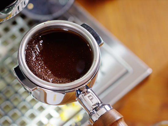 puck of espresso with pooled water lifestyle by clive coffee 