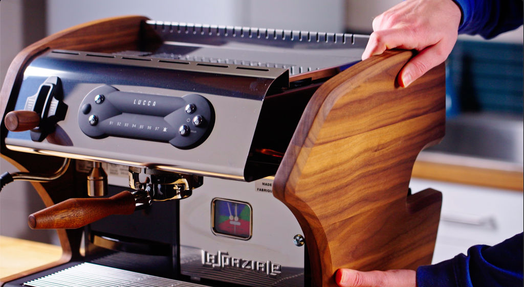 Talent placing magnetic wood panels on the side of the machine lifestyle by clive coffee